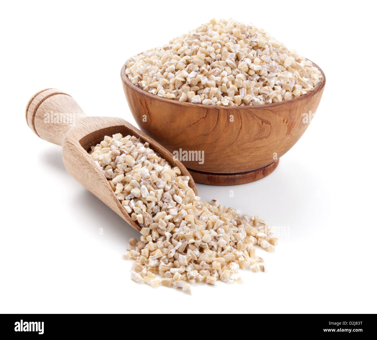 barley grits in a wooden bowl isolated on white background Stock Photo