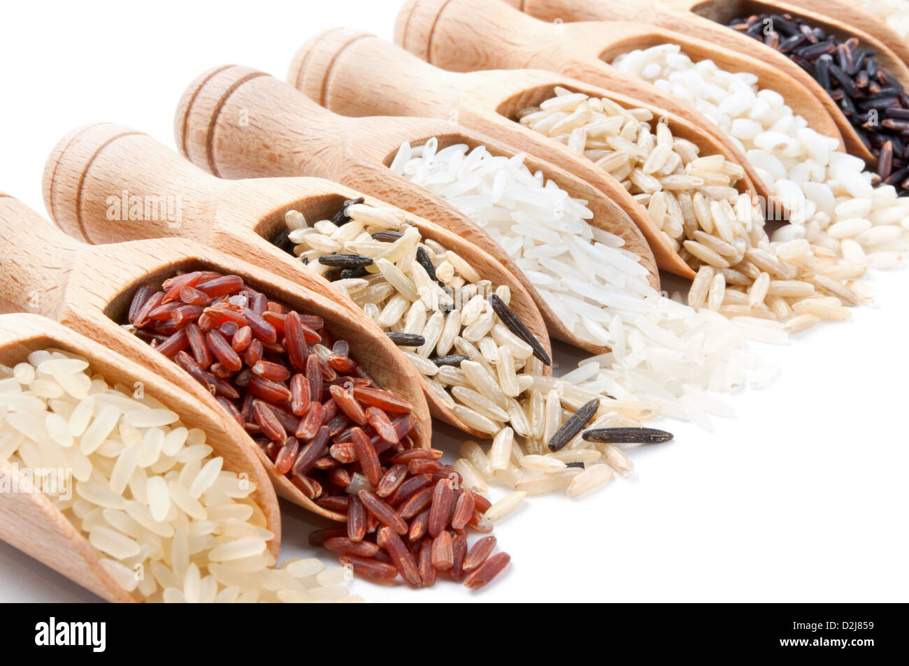 Slops Food Rice Wooden scoops with different rice types scattered from them on white ...