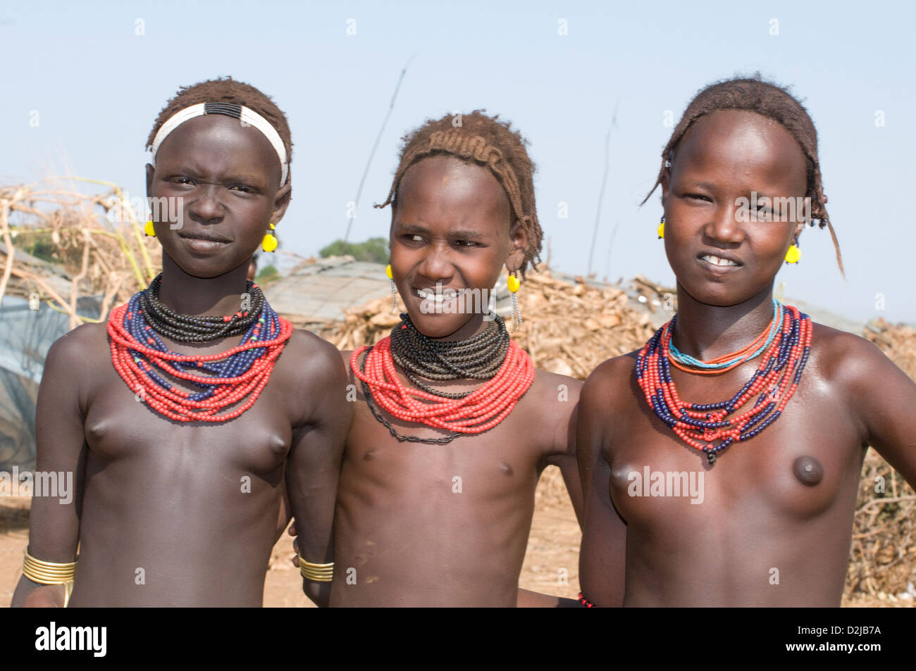 Close of three Dassenech girls together wearing beaded necklaces Stock Photo