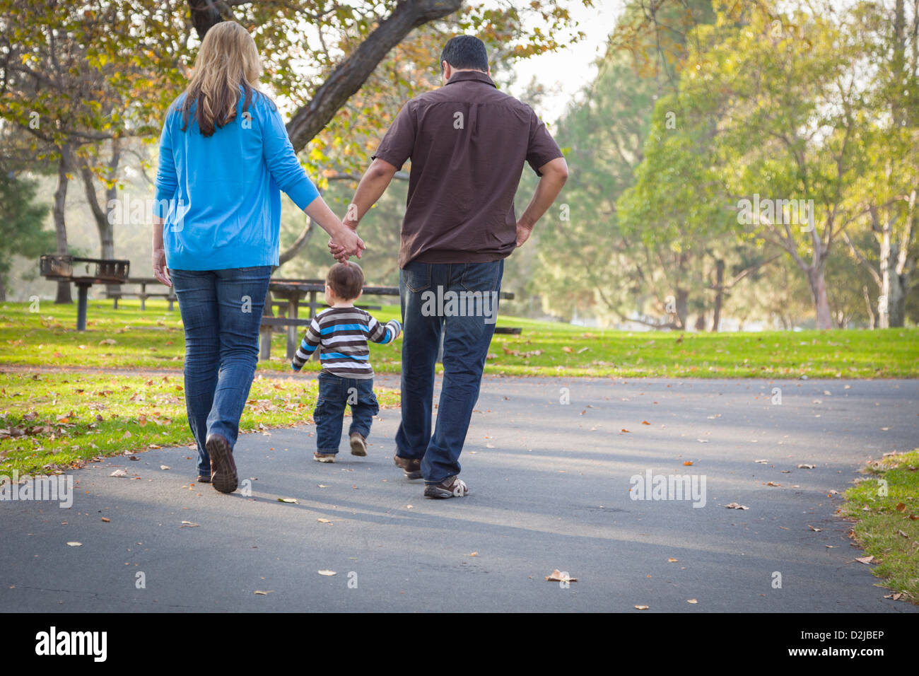 Happy Young Mixed Race Ethnic Family Walking In The Park Stock Photo ...