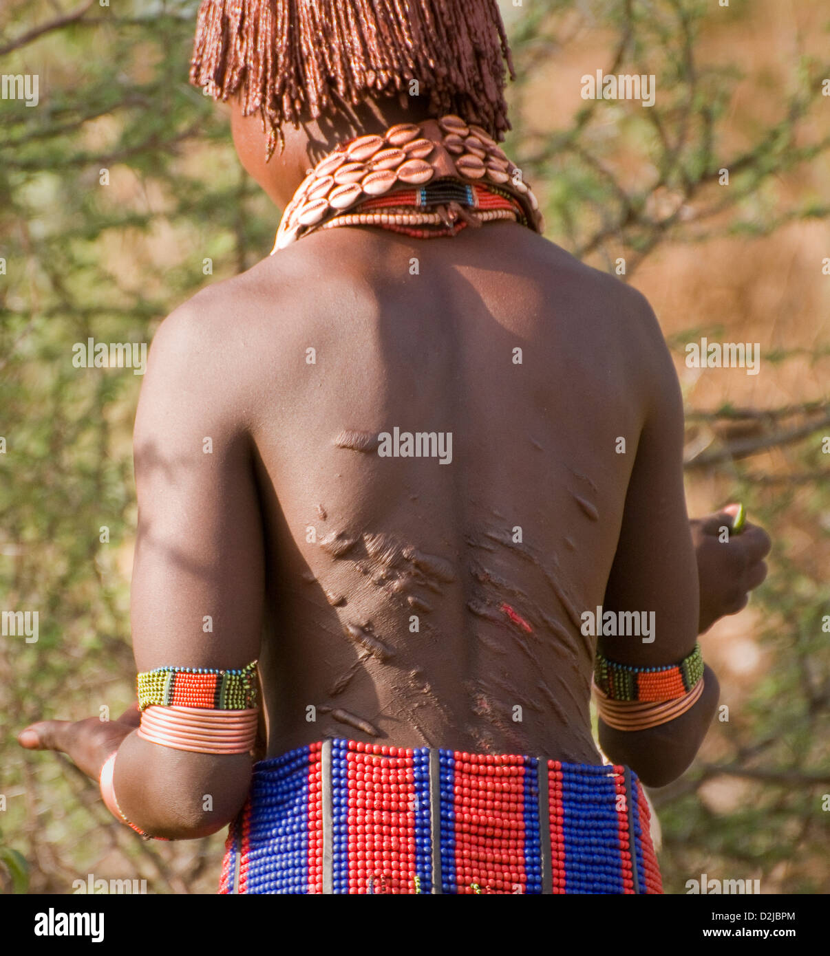 Hamar woman with scars on back from whipping during ceremony Stock Photo