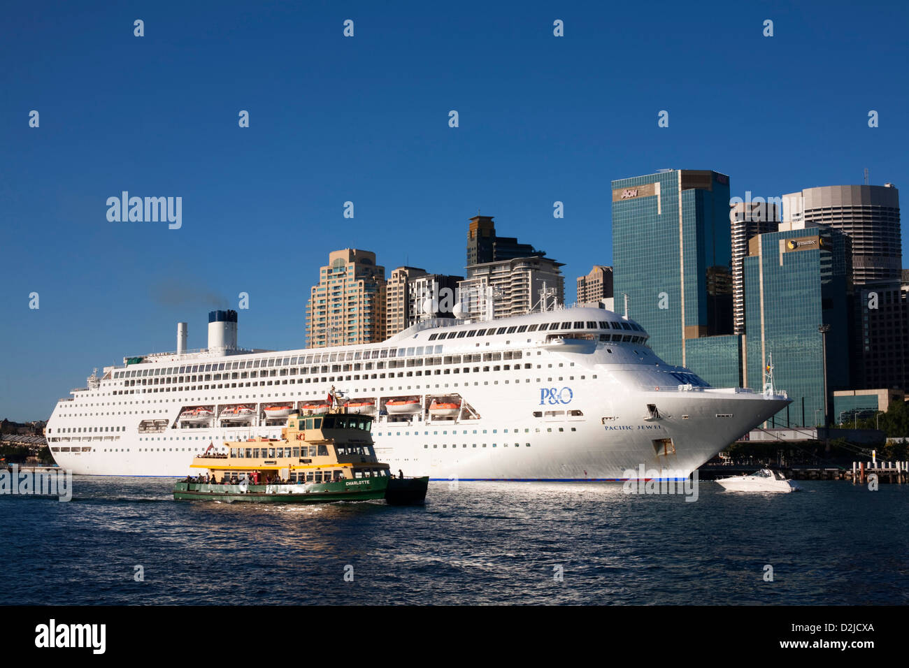 Sydney Harbour Ferry 'Charlotte' passing P&O Cruises superliner, 'Pacific Jewel' as she departs from Sydney Australia Stock Photo