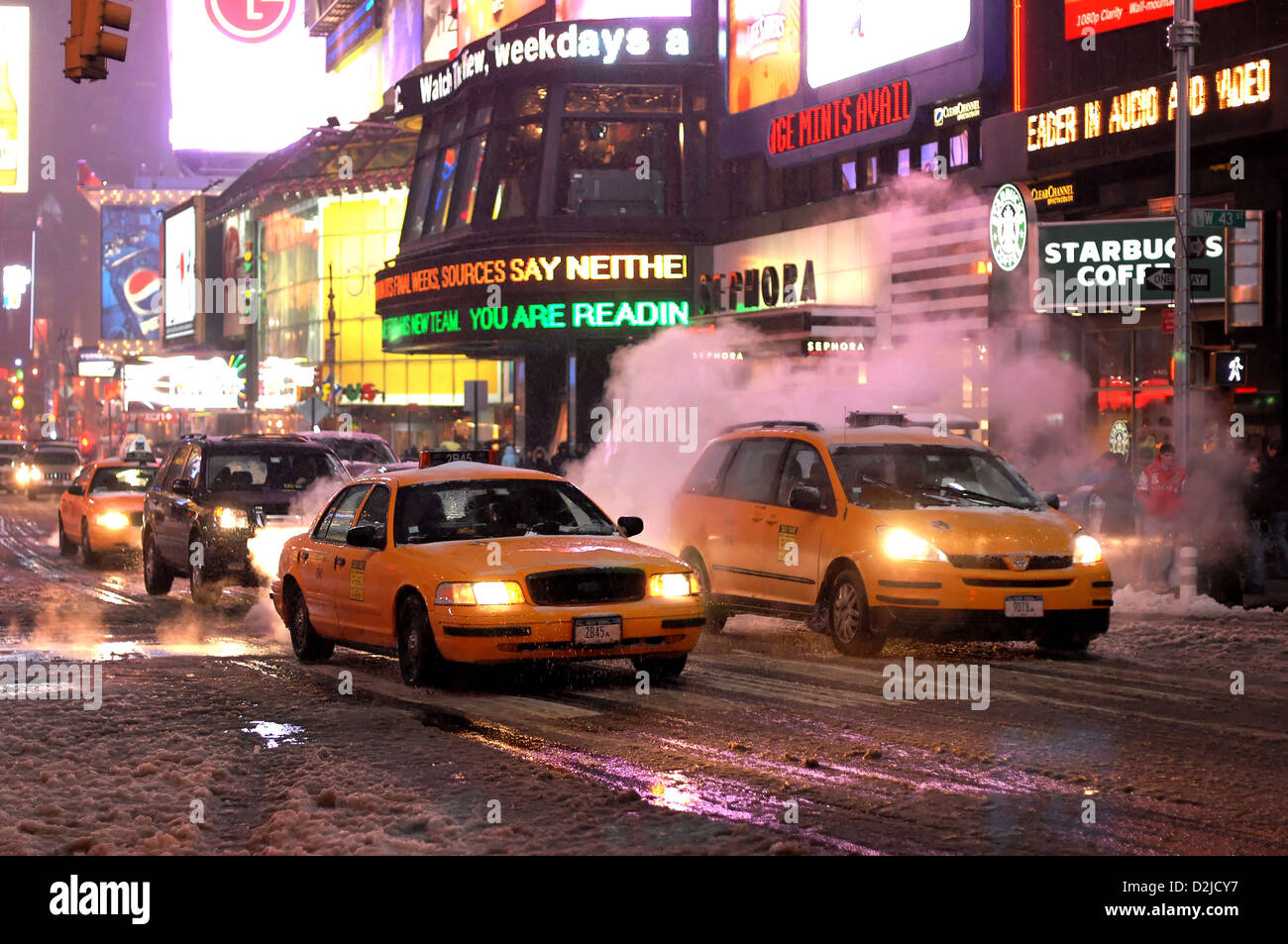 New York City, USA, Yellow Cabs driving in Times Square by smoking