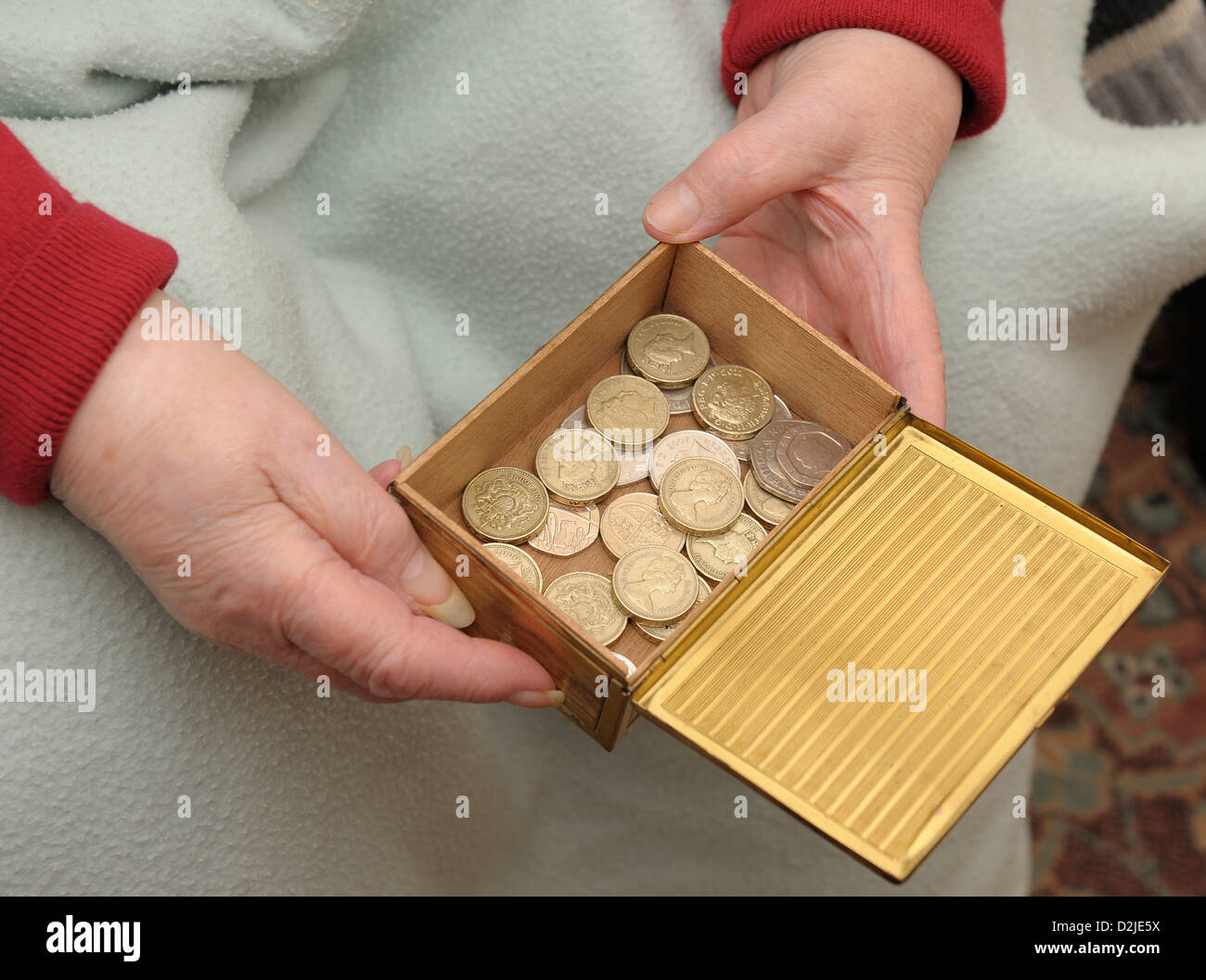 pensioner holding money box Stock Photo