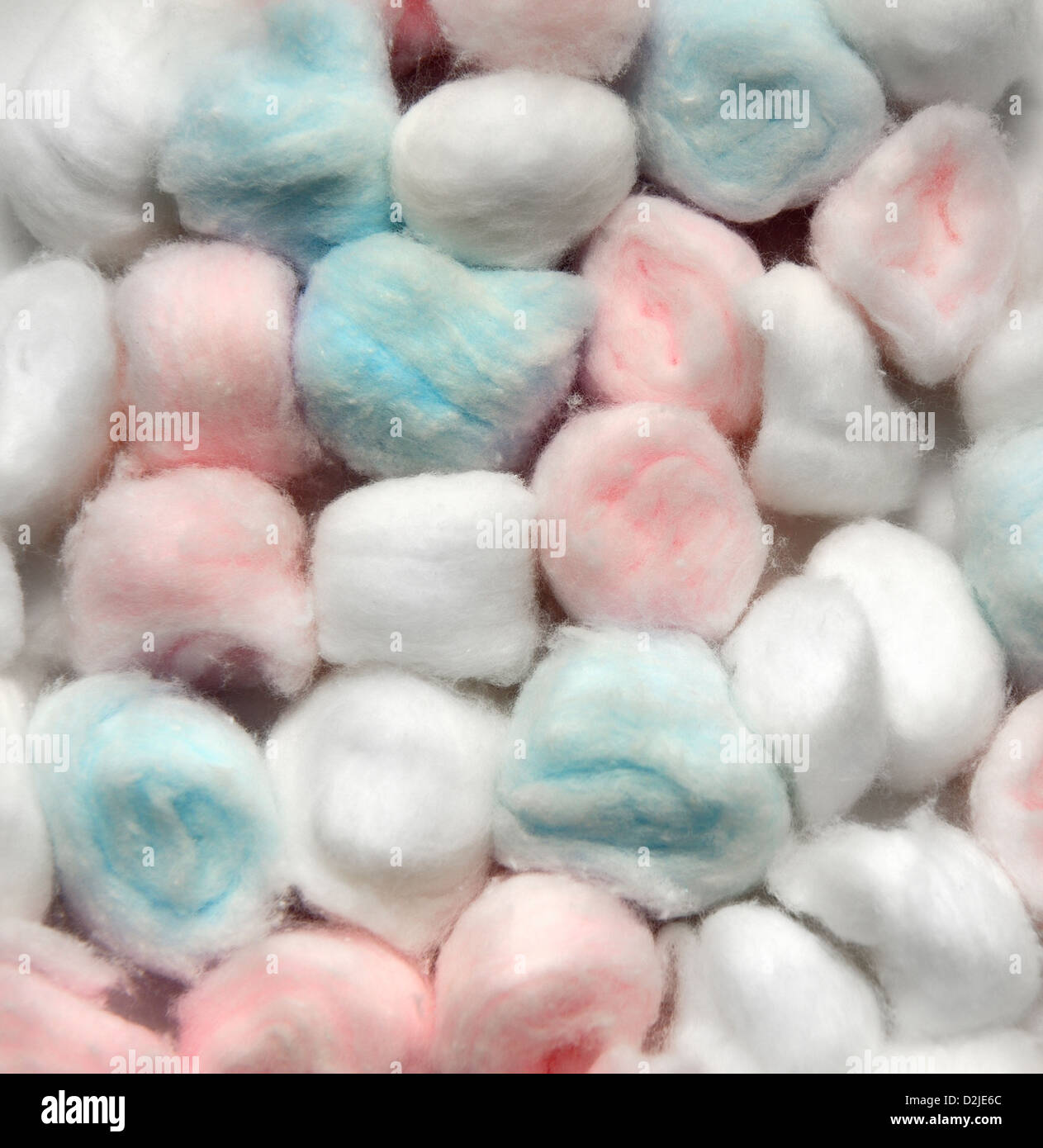 Colorful Small Cotton Balls Inside A Striped Box Stock Photo