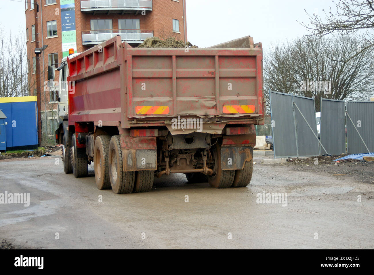 Large heavily loaded truck taking earth out of a construction project into a residential area 9th March 2006 Stock Photo