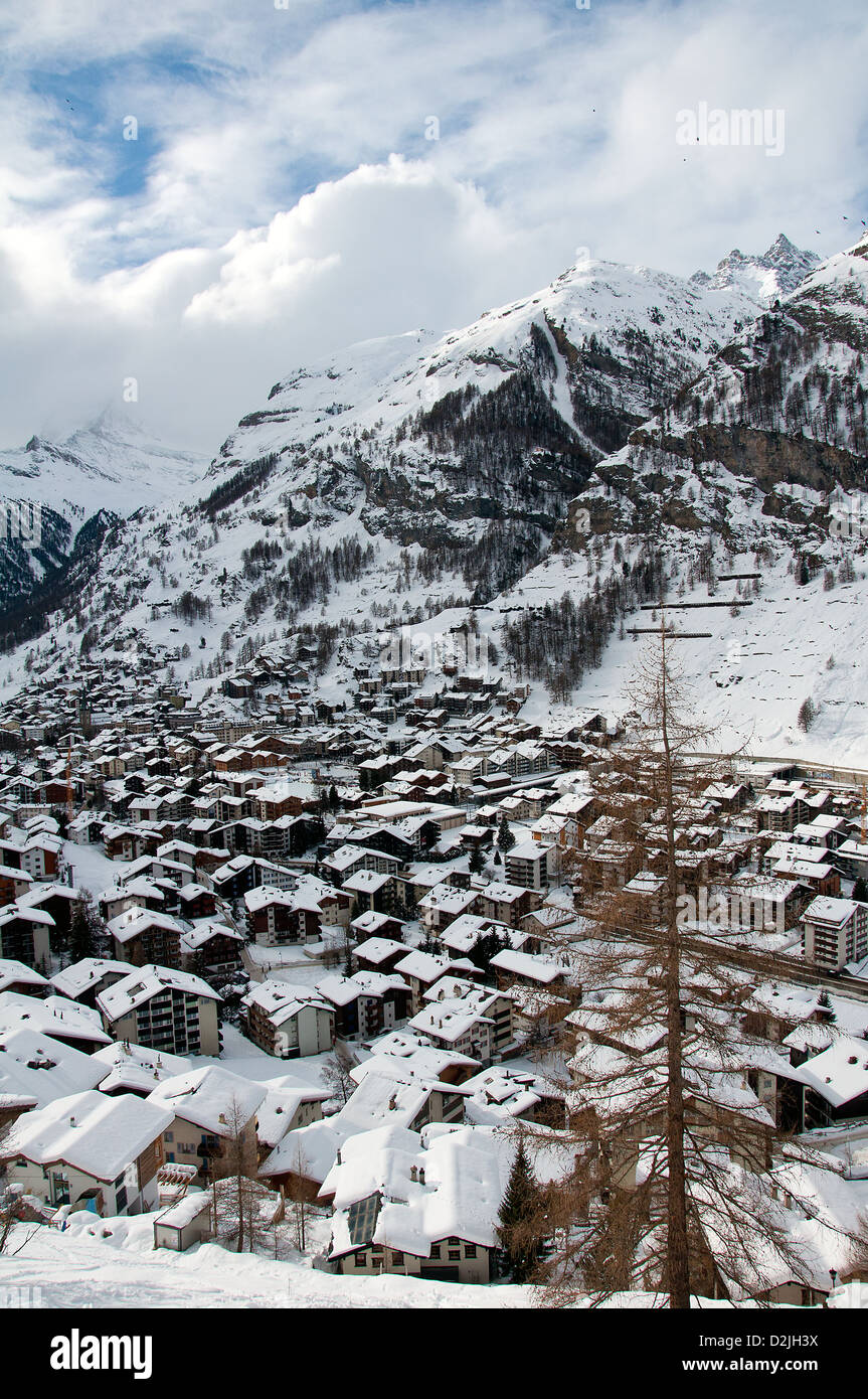 With snow covered houses in Zermatt village, Valais, Switzerland Stock