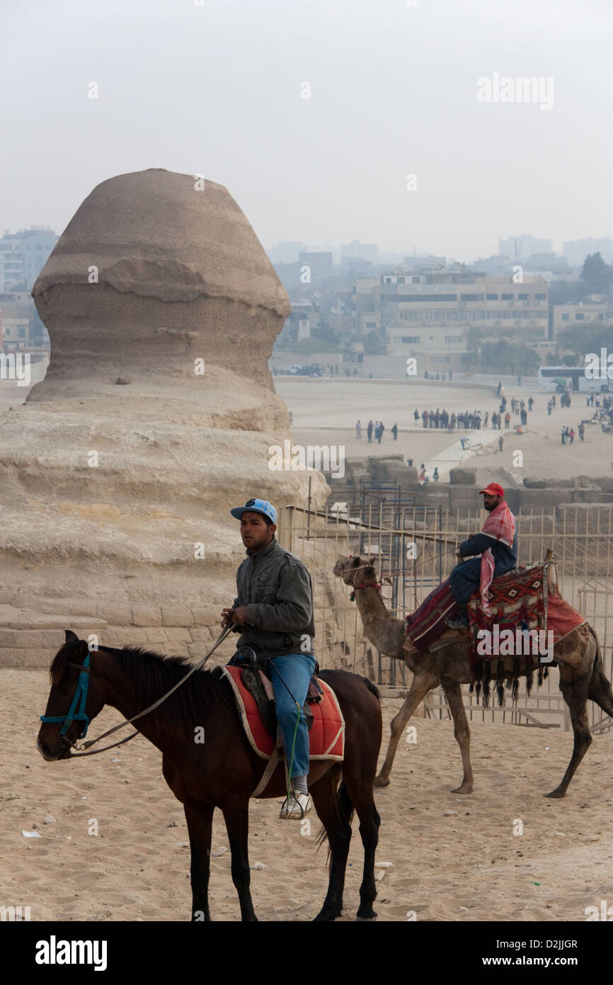 Cairo, Egypt, Arab horsemen in front of the back of the head of the Sphinx Stock Photo