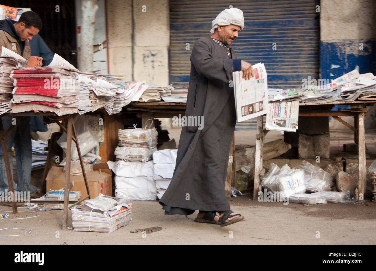 Cairo, Egypt, in the Arab galabeya buy a newspaper at a newsstand Stock Photo