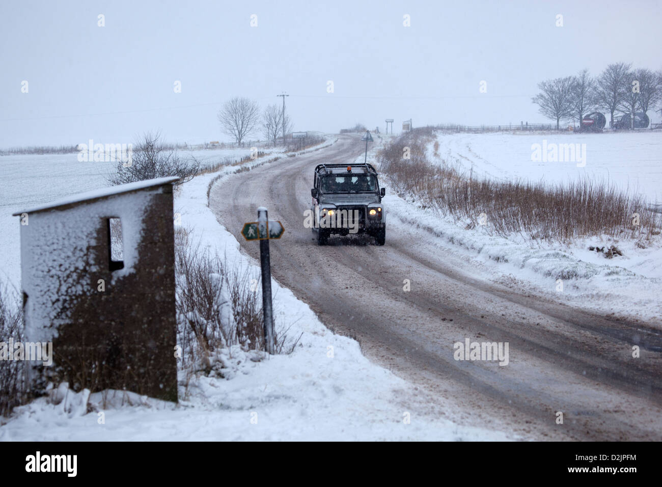 Car driving through the snow near Stanton St Bernard Road Stock Photo