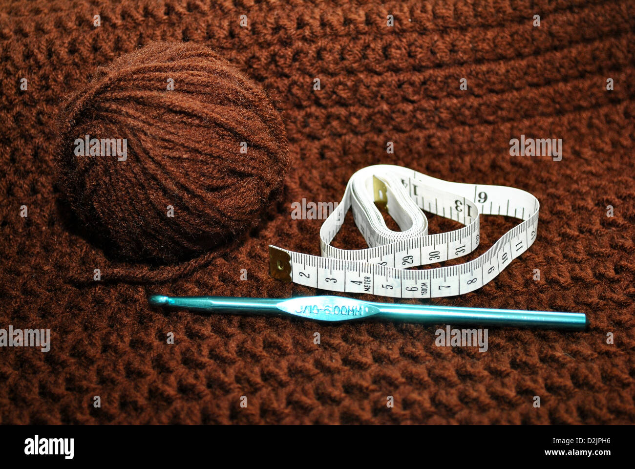 Brown Yarn, Crochet Hook and Tape Measure Stock Photo