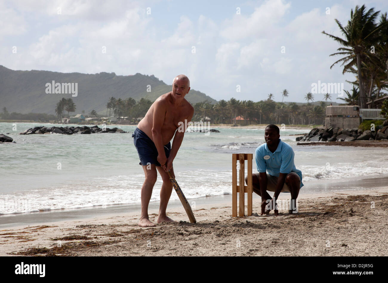 Tourists playing beach cricket, St Lucia, Stock Photo
