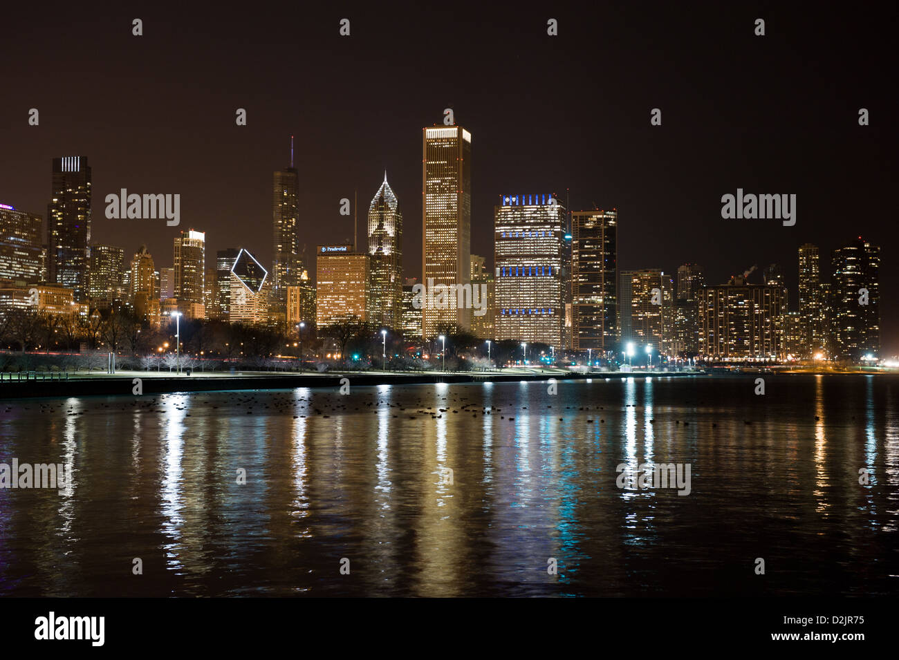 Night view of the Chicago skyline with Lake Michigan in the foreground ...
