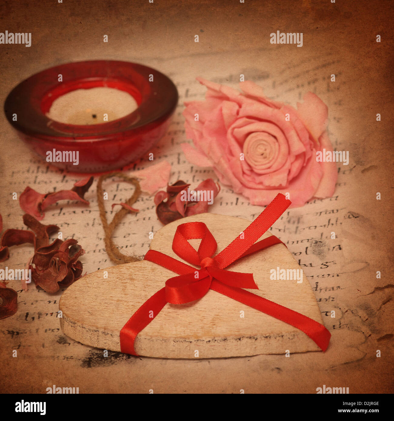 Vintage Holidays heart with a rose on old letter Stock Photo