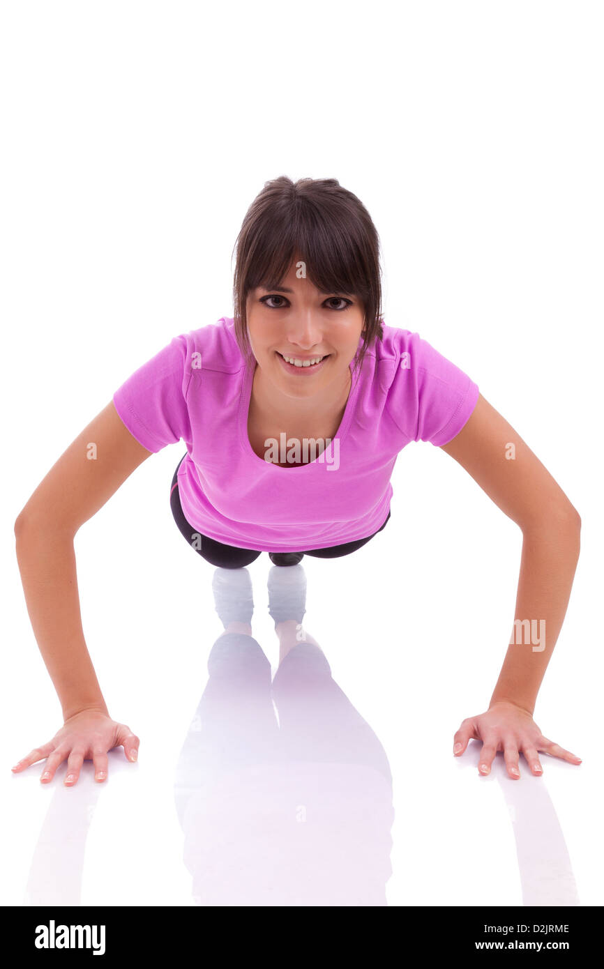 Young beautiful caucasian fitness woman doing push up exercises on floor,isolated on white background Stock Photo