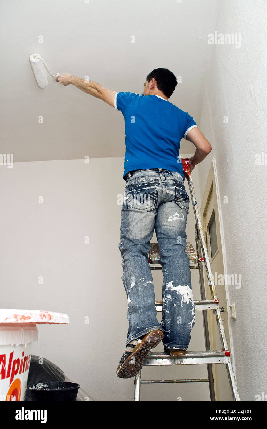 Berlin Germany Man On Ladder Highlights The Ceiling Stock Photo