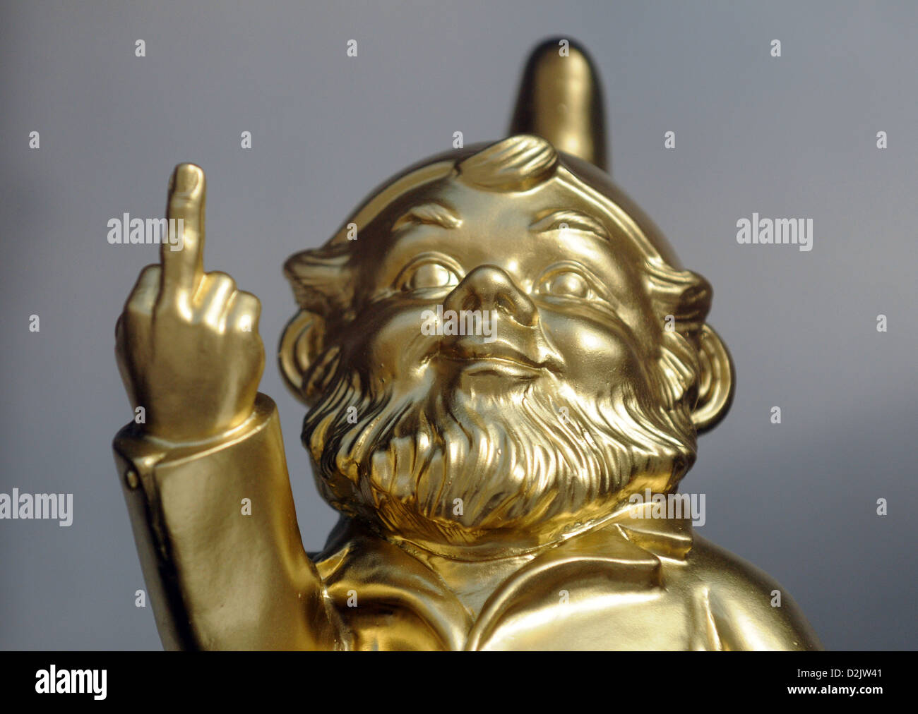 Berlin, Germany, golden garden gnome shows the finger Stock Photo