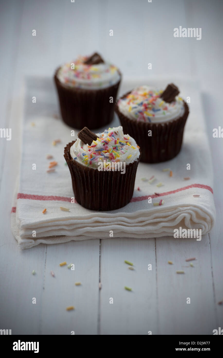 Cupcakes decorated with sprinkles and a chocolate flake Stock Photo