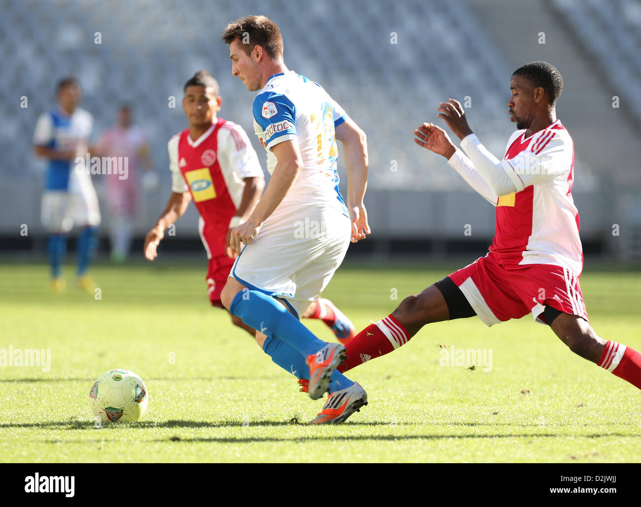 CAPE TOWN, South Africa - Saturday 26 January 2013, Izet Hajrovic of Grasshopper Club Zurich is challenged by Abia Nale of Ajax Cape Town during the soccer/football match Grasshopper Club Zurich (Switzerland) and Ajax Cape Town at the Cape Town stadium. Photo by Roger Sedres/ImageSA/ Alamy Live News Stock Photo