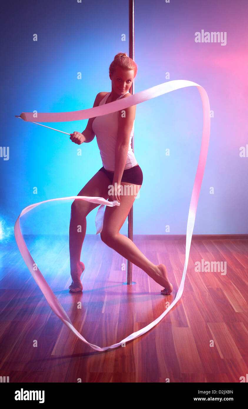 Young pole dance woman with ribbon. Stock Photo