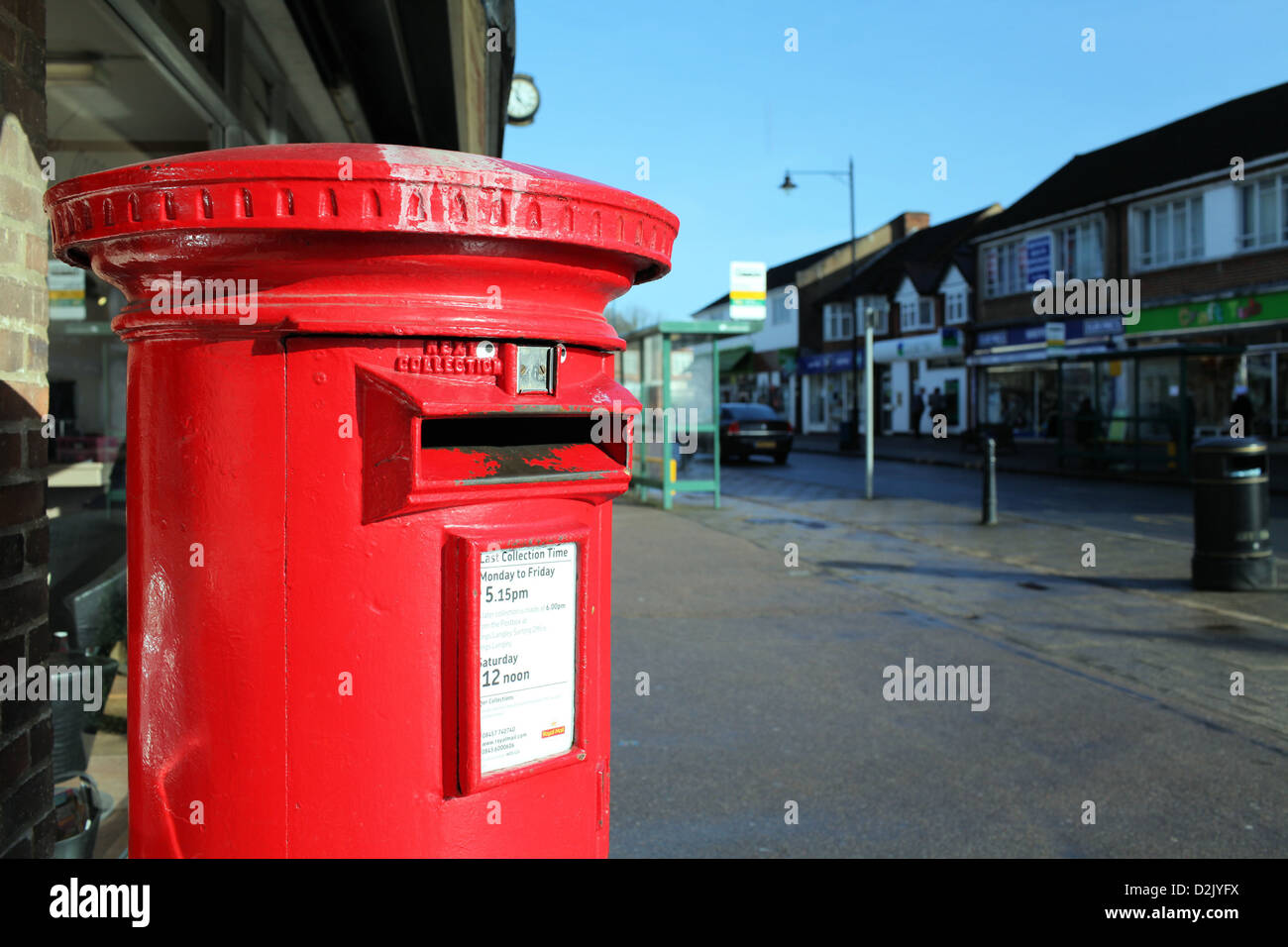 Red post box on Abbots Langley High Street, Hertfordshire Stock Photo