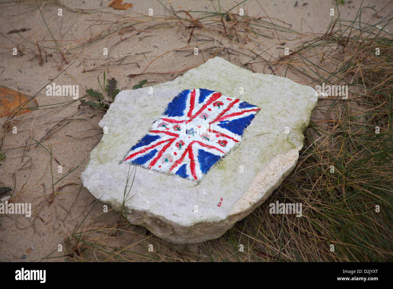 Painting on stone on beach at Hengistbury Head, Dorset in January Stock Photo