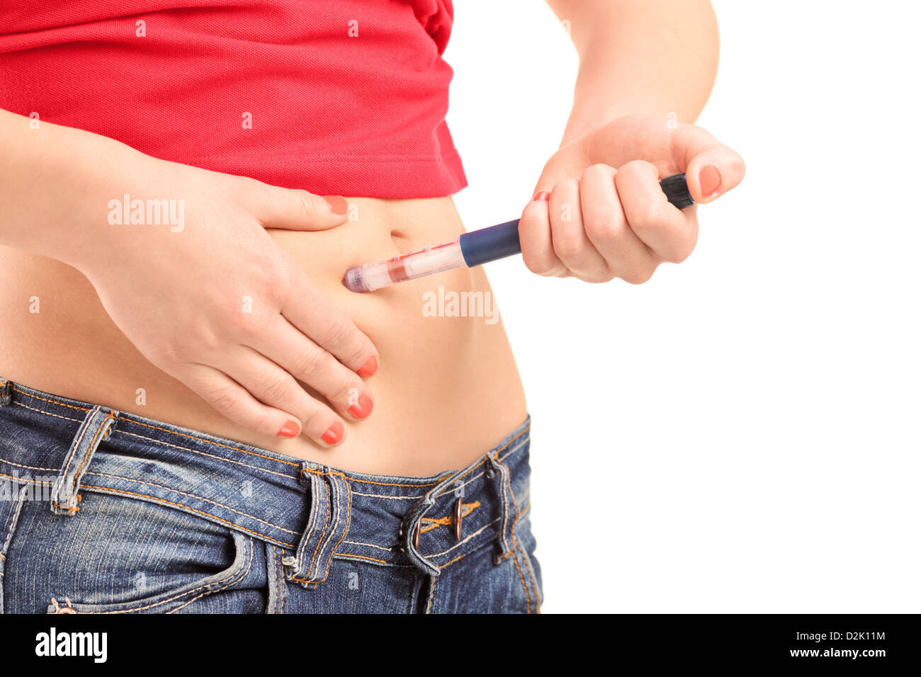 Young female injecting insulin in her abdomen isolated on white background Stock Photo
