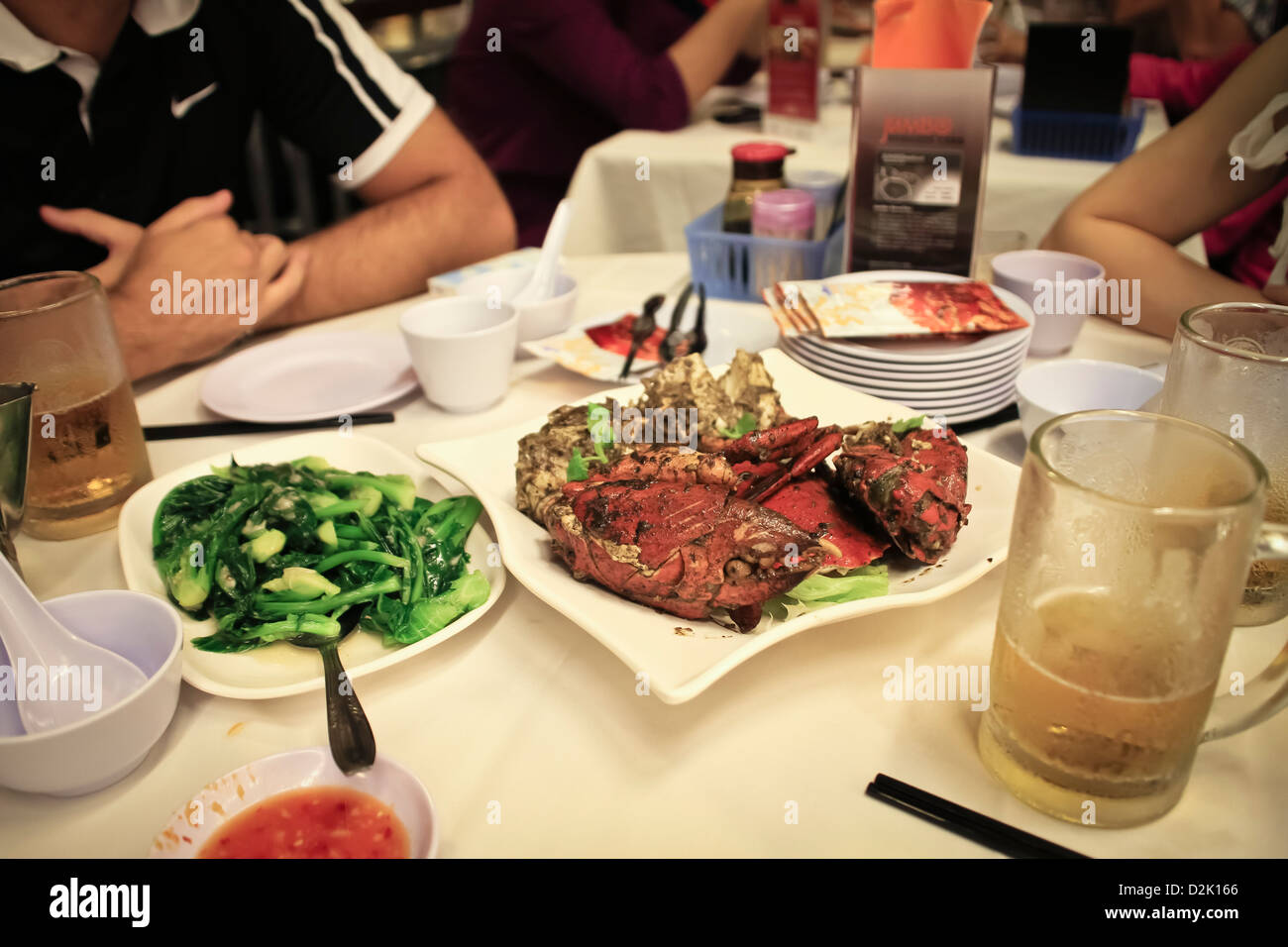 Eating a dinner at seafood restaurant in Singapore, with Crab in pepper for the main course Stock Photo