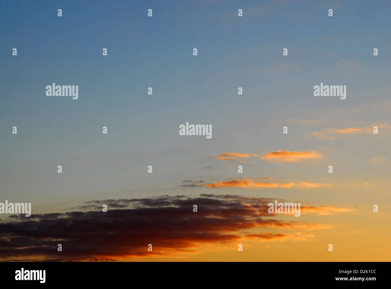 Orange and purple clouds and dark blue sky at sunset Stock Photo - Alamy