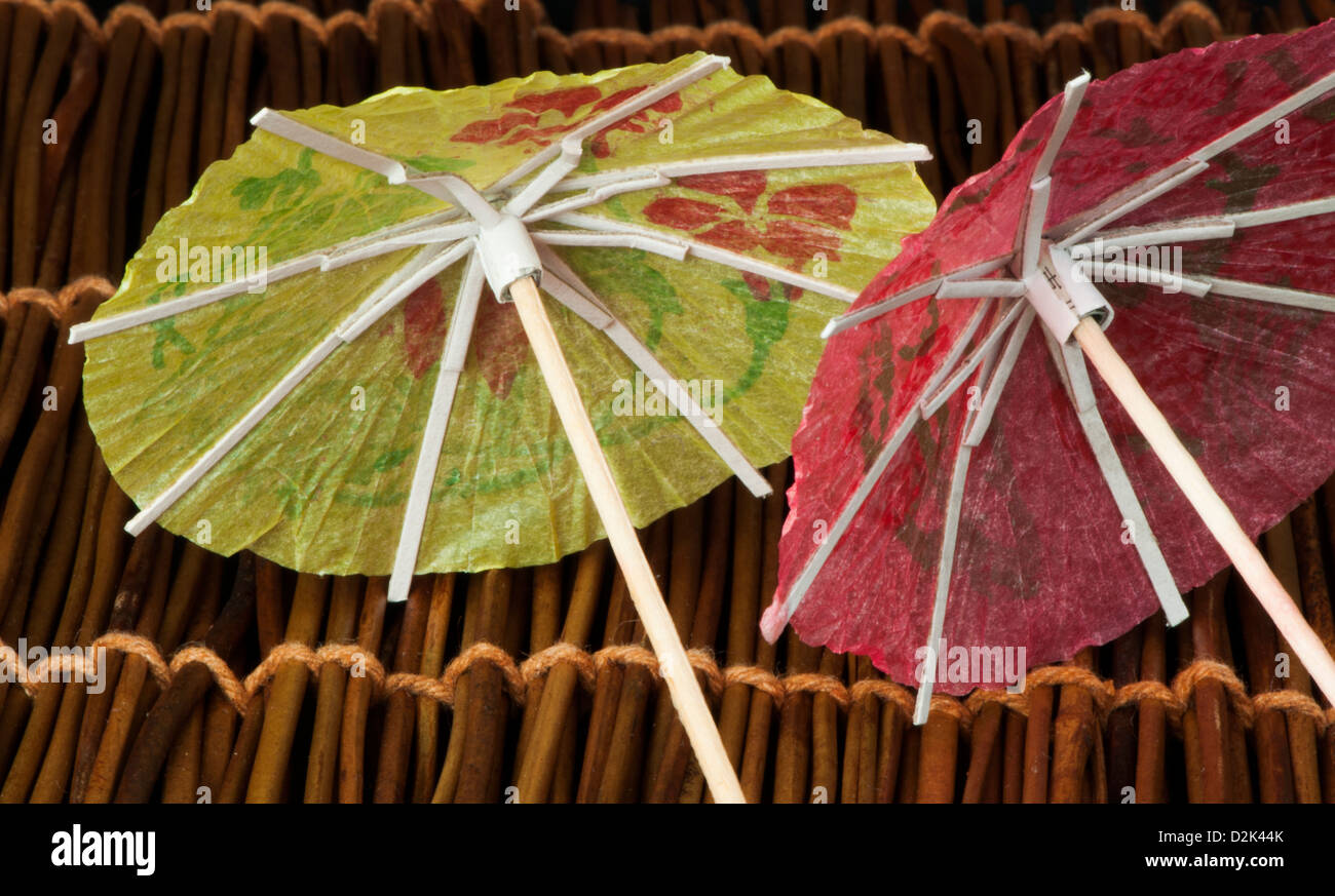 Colorful cocktail umbrellas on wooden base. Close up Stock Photo
