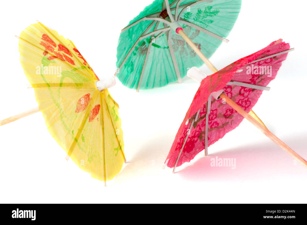 Colorful cocktail umbrellas white isolated. Close up Stock Photo