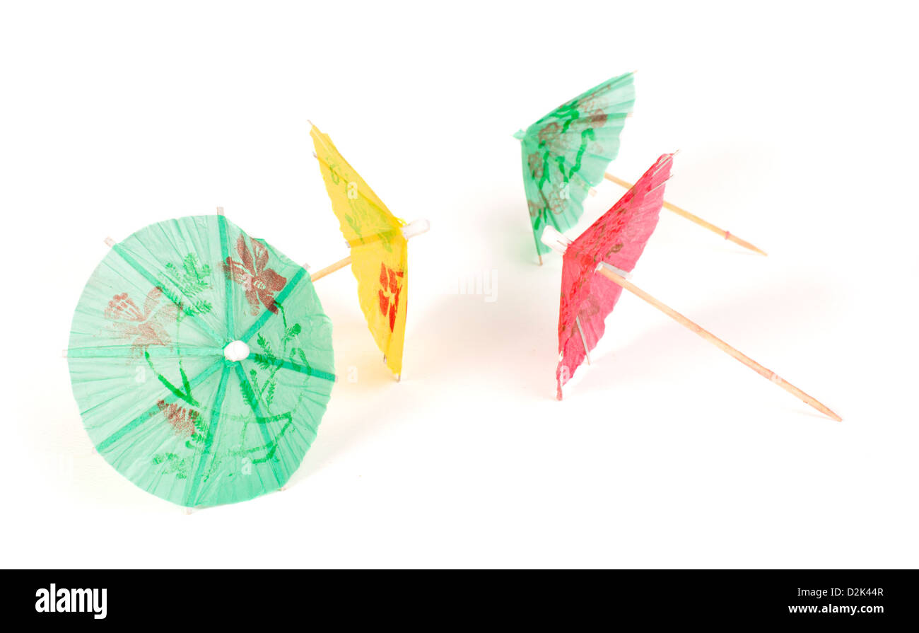 Colorful cocktail umbrellas white isolated. Close up Stock Photo