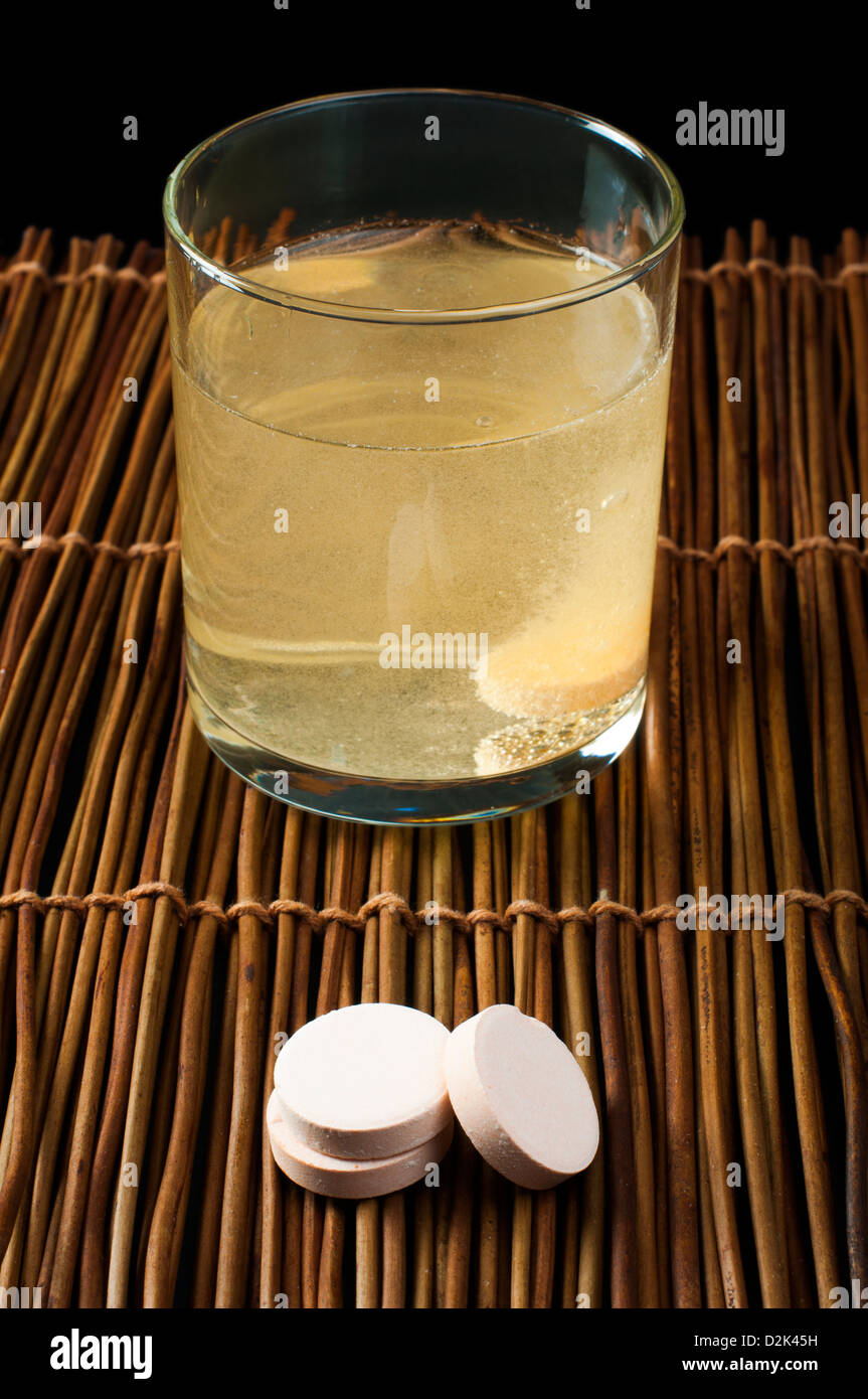 Vitamins pills soluble in water. Glass of water with vitamins. Stock Photo