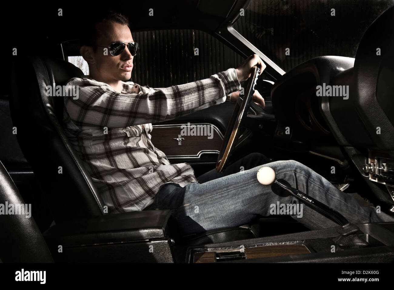 Young man at steering wheel of Ford Mustang Boss 429 sports car Stock Photo