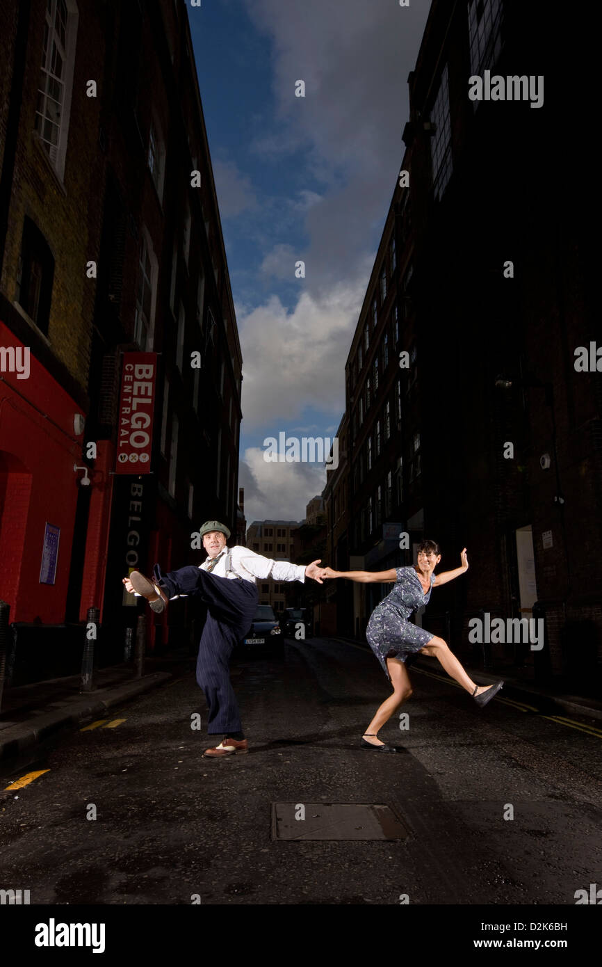 Man and woman lindy hop dancing in urban street Stock Photo