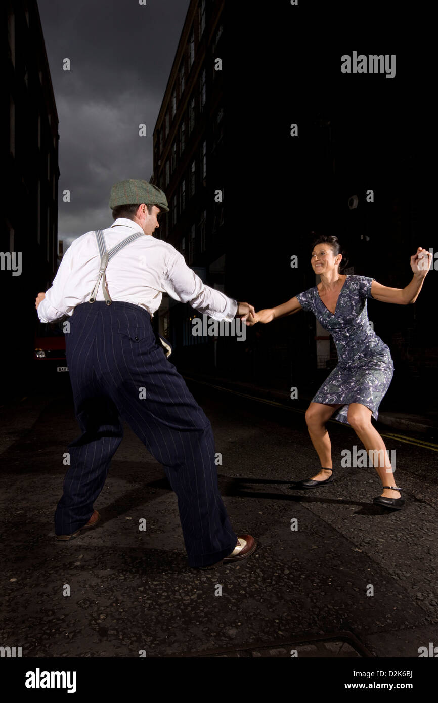 Couple lindy hop dancing in urban street Stock Photo
