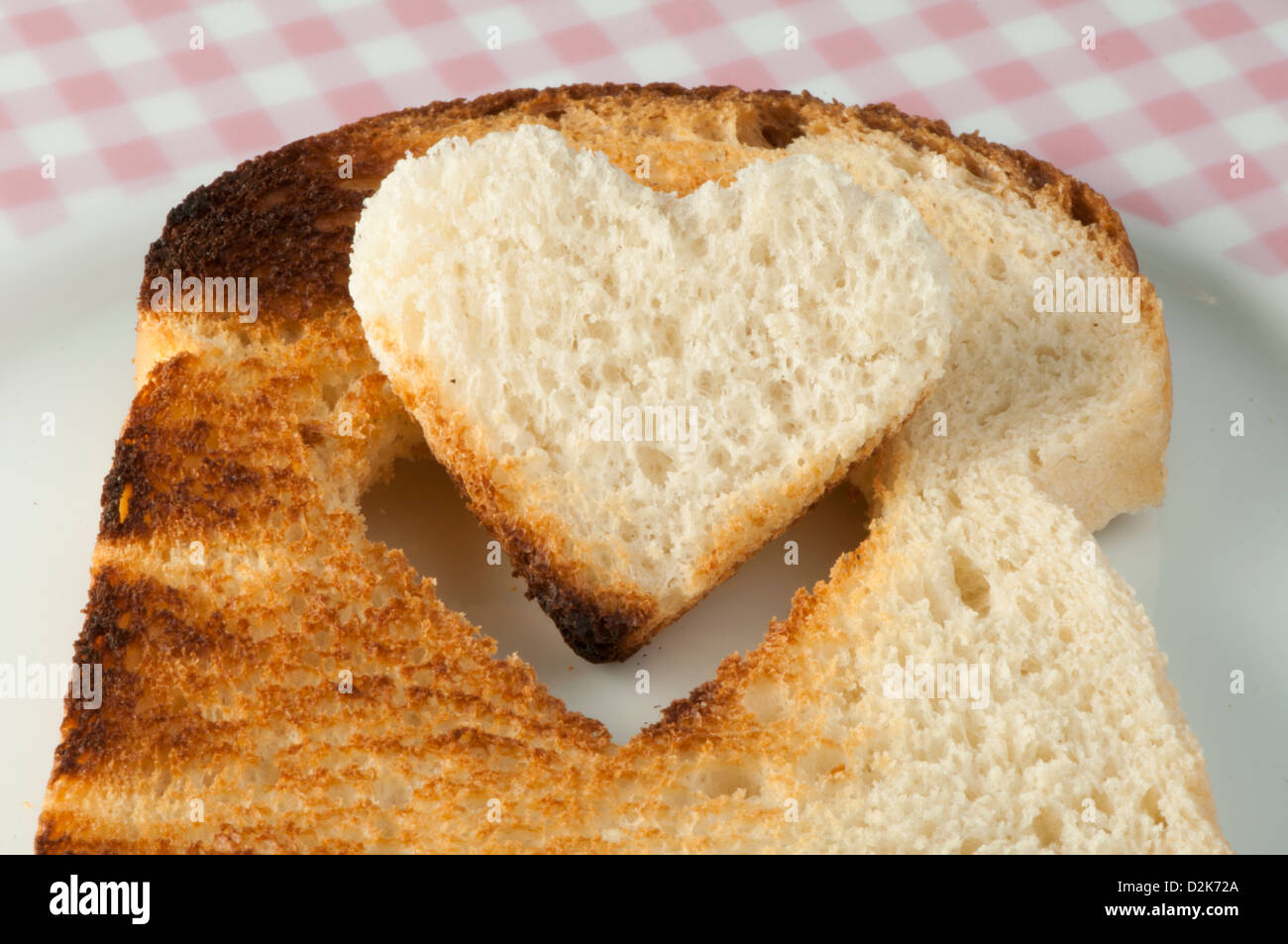 Toast with heartshaped set in white plate Stock Photo Alamy