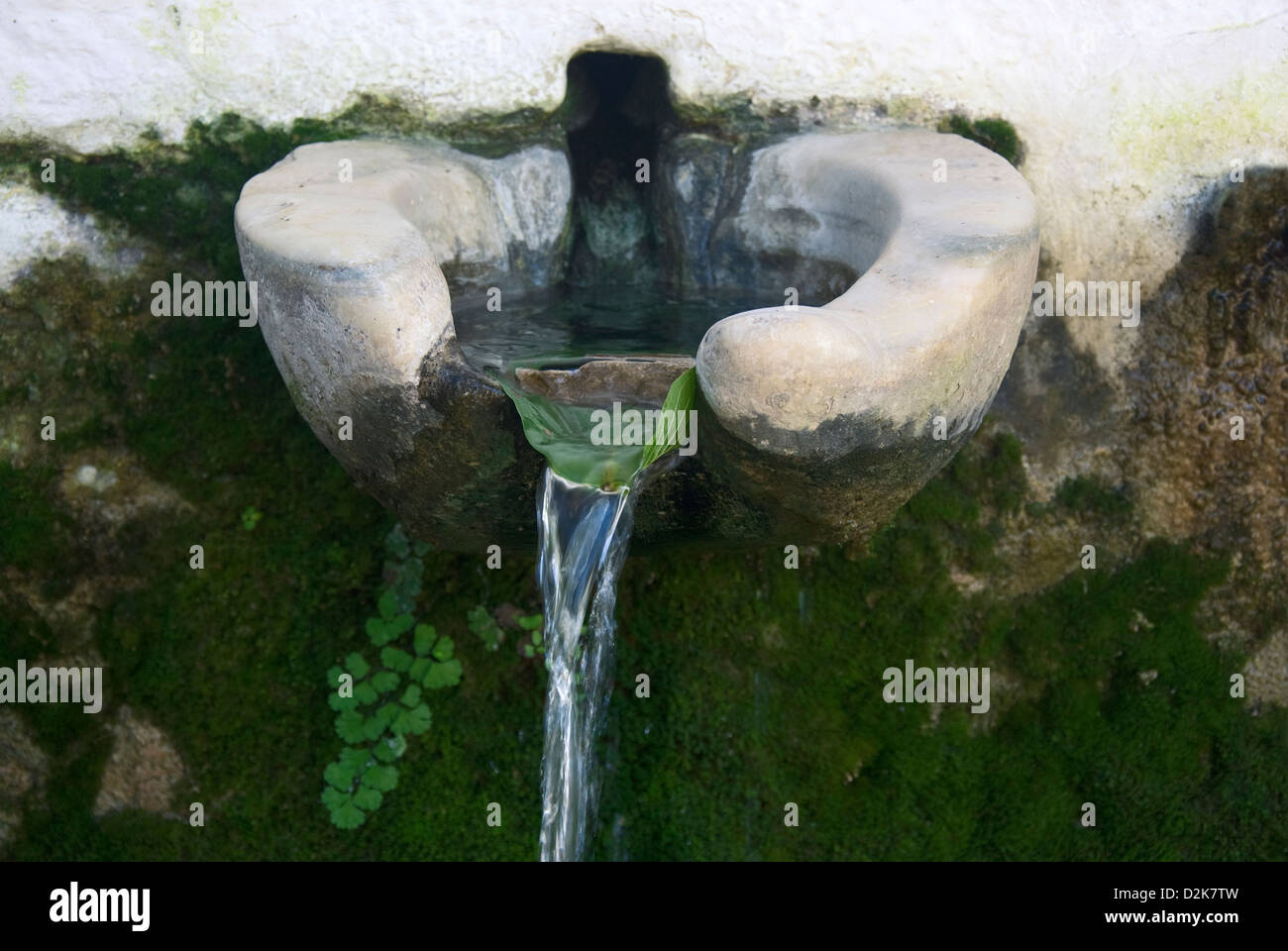Old drinking fountain with spring water (Greece) Stock Photo