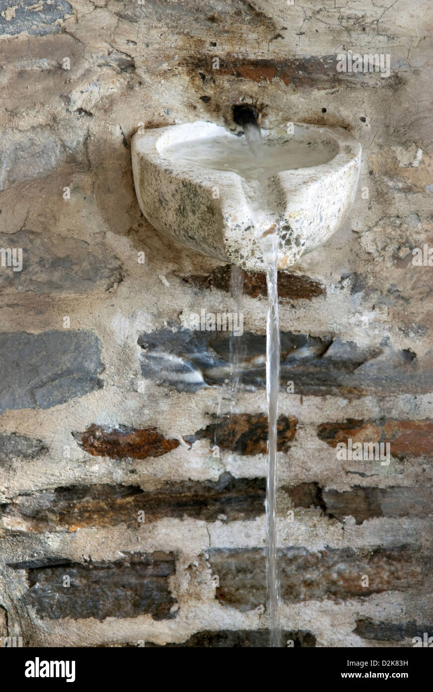Old drinking fountain with spring water (Greece) Stock Photo