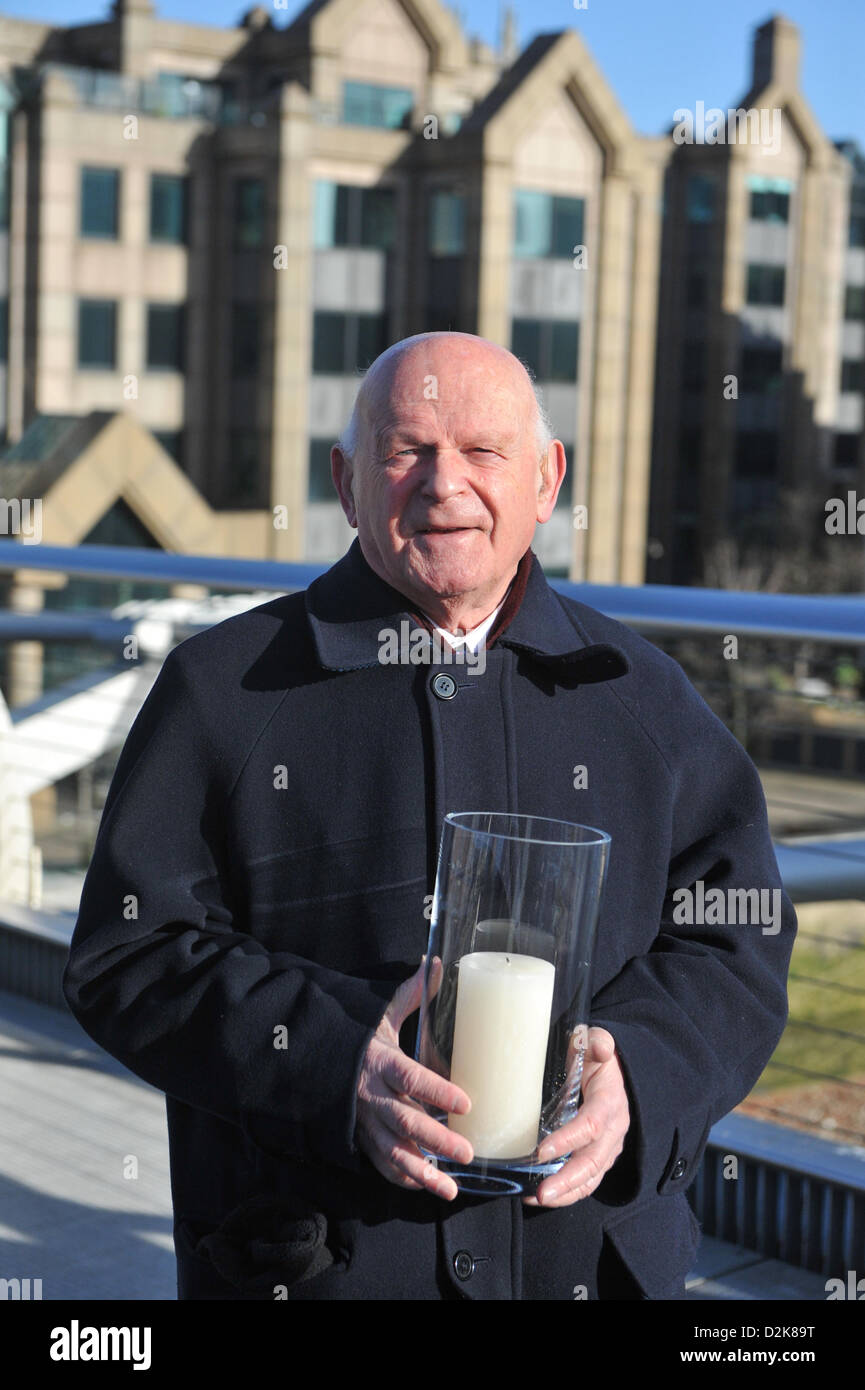 Millenium Bridge, London, UK. 27th January 2013. Ben Helfgott, a survivor of the Holocaust, holds a candle lit in remembrance of those who died, as the Holocaust Memorial Day commemoration takes place at the Millennium Bridge. A choir and survivors of the Holocaust took part in the ceremony. Credit: Matthew Chattle/Alamy Live News Stock Photo