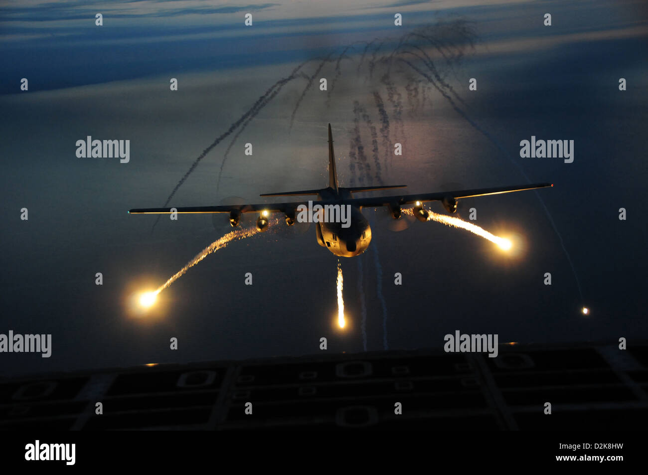 A C-130 night training mission uses live flares as an aerial infrared countermeasure used to defeat infrared homing (heat seeking) surface-to-air or air-to-air missiles Sept. 25, 2012 around Niagara Falls, New York. Stock Photo