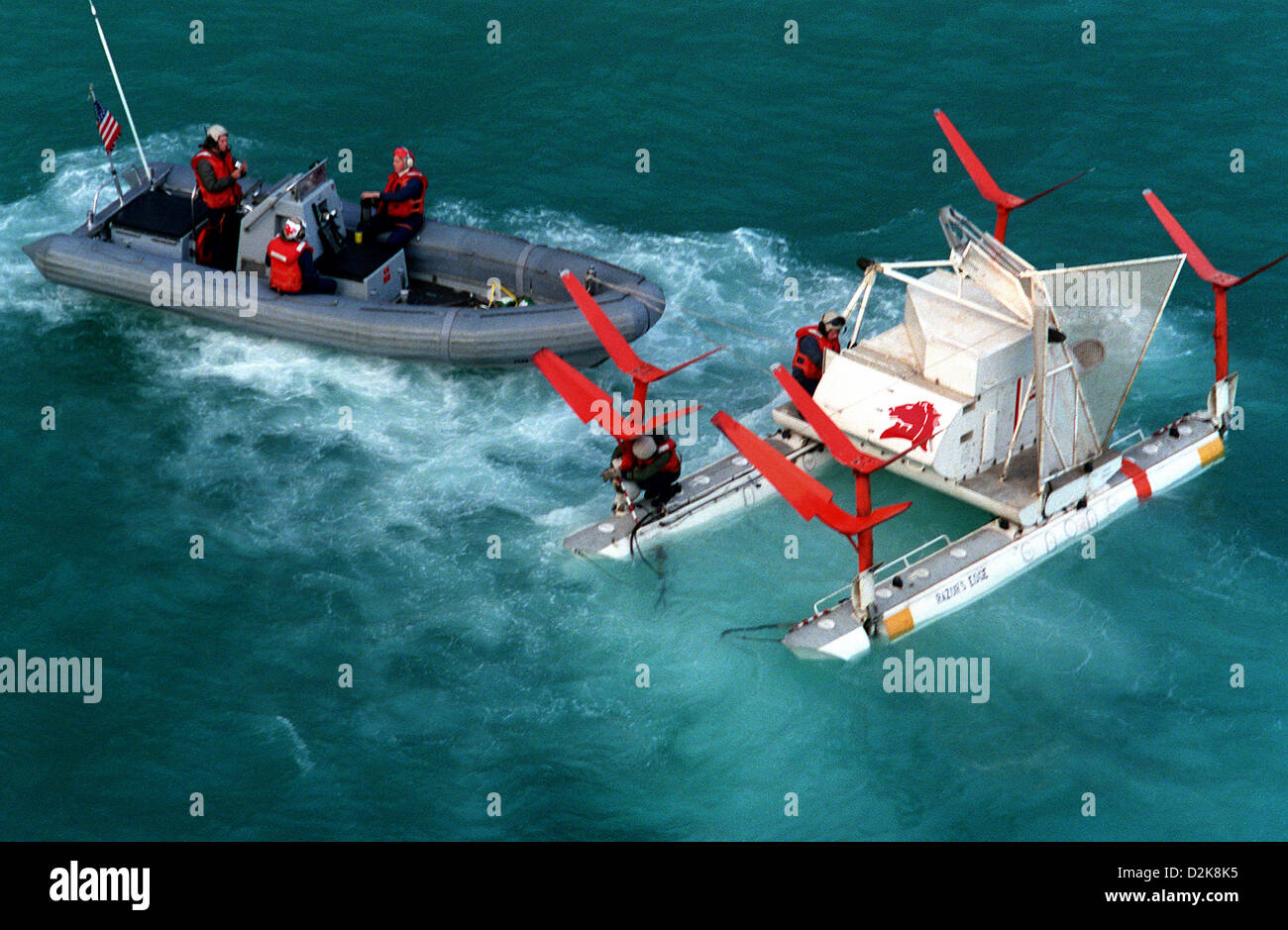 Three members of Helicopter Mine Countermeasures stand by in a small
