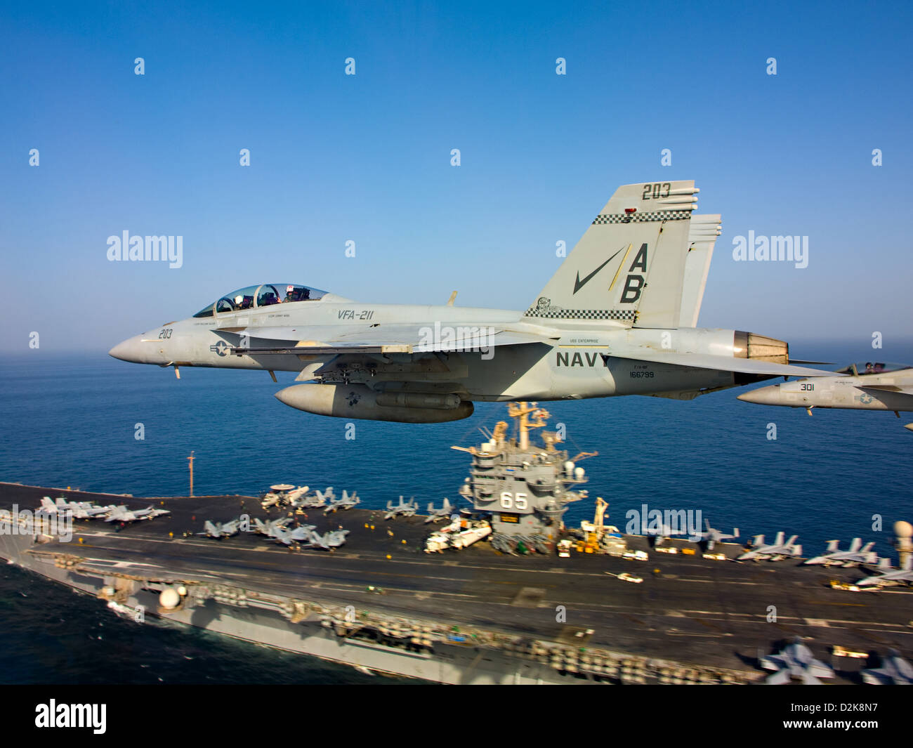 Two F/A-18 Super Hornets fly above aircraft carrier USS Enterprise October 4, 2012 in the Arabian Sea. Stock Photo