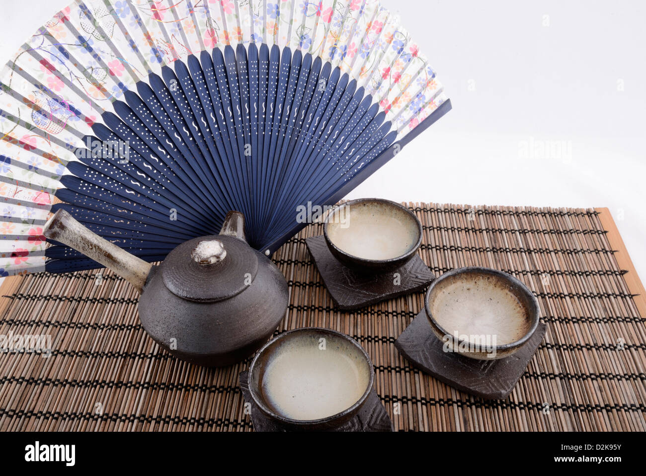 Chinese tea set still images with beautiful traditional fan background. Stock Photo