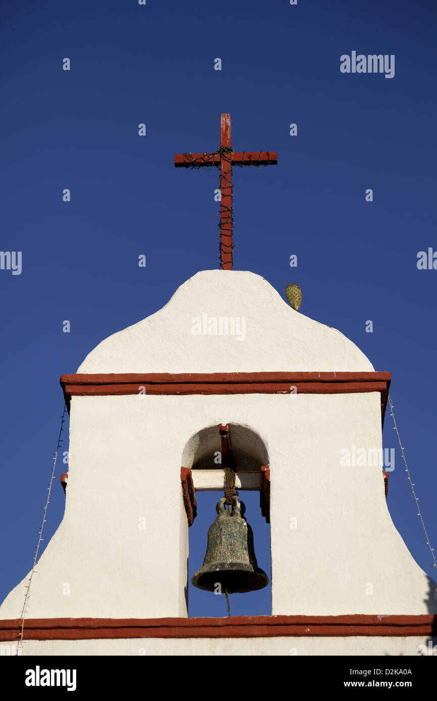Cross and a cactus on top of white bell tower, the campanile is part of the Mission San Antonio de Pala Stock Photo