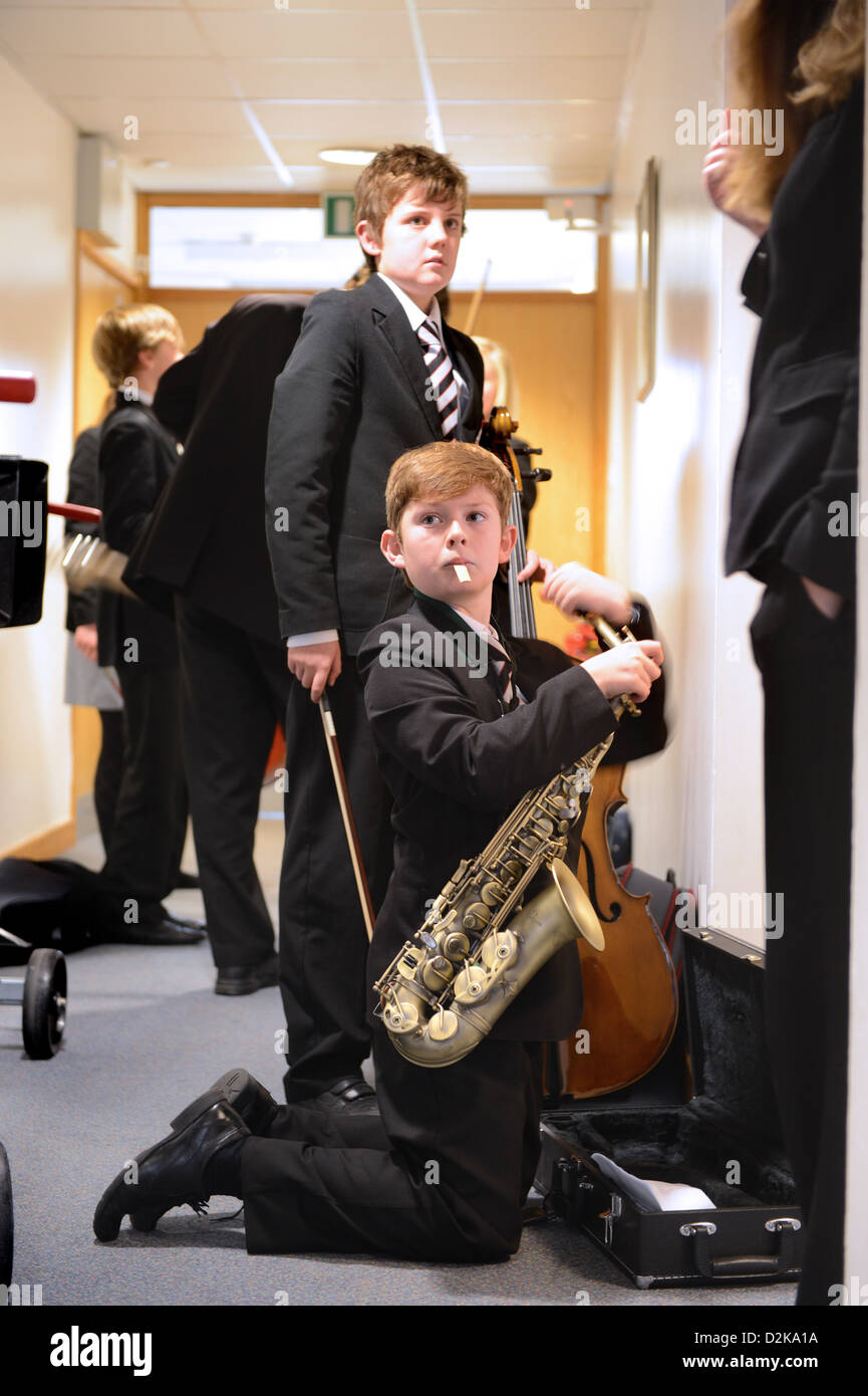 A boy with his saxophone before a concert at Pates Grammar School in Cheltenham, Gloucestershire UK Stock Photo