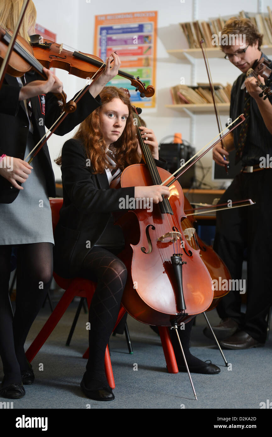 A girl with a cello during an orchestra practice at Pates Grammar School in Cheltenham, Gloucestershire UK Stock Photo