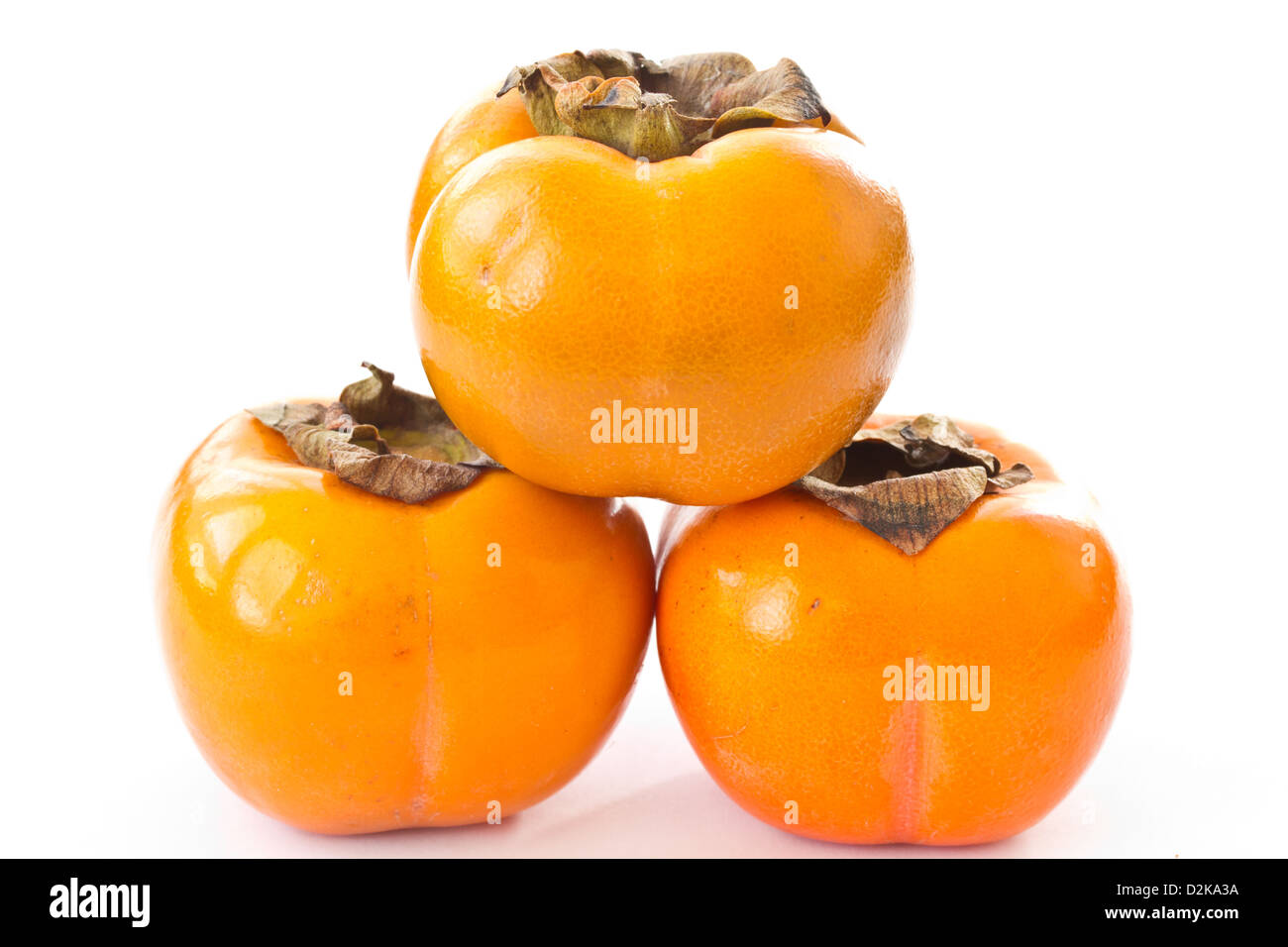 three ripe orange persimmons on a white background Stock Photo - Alamy