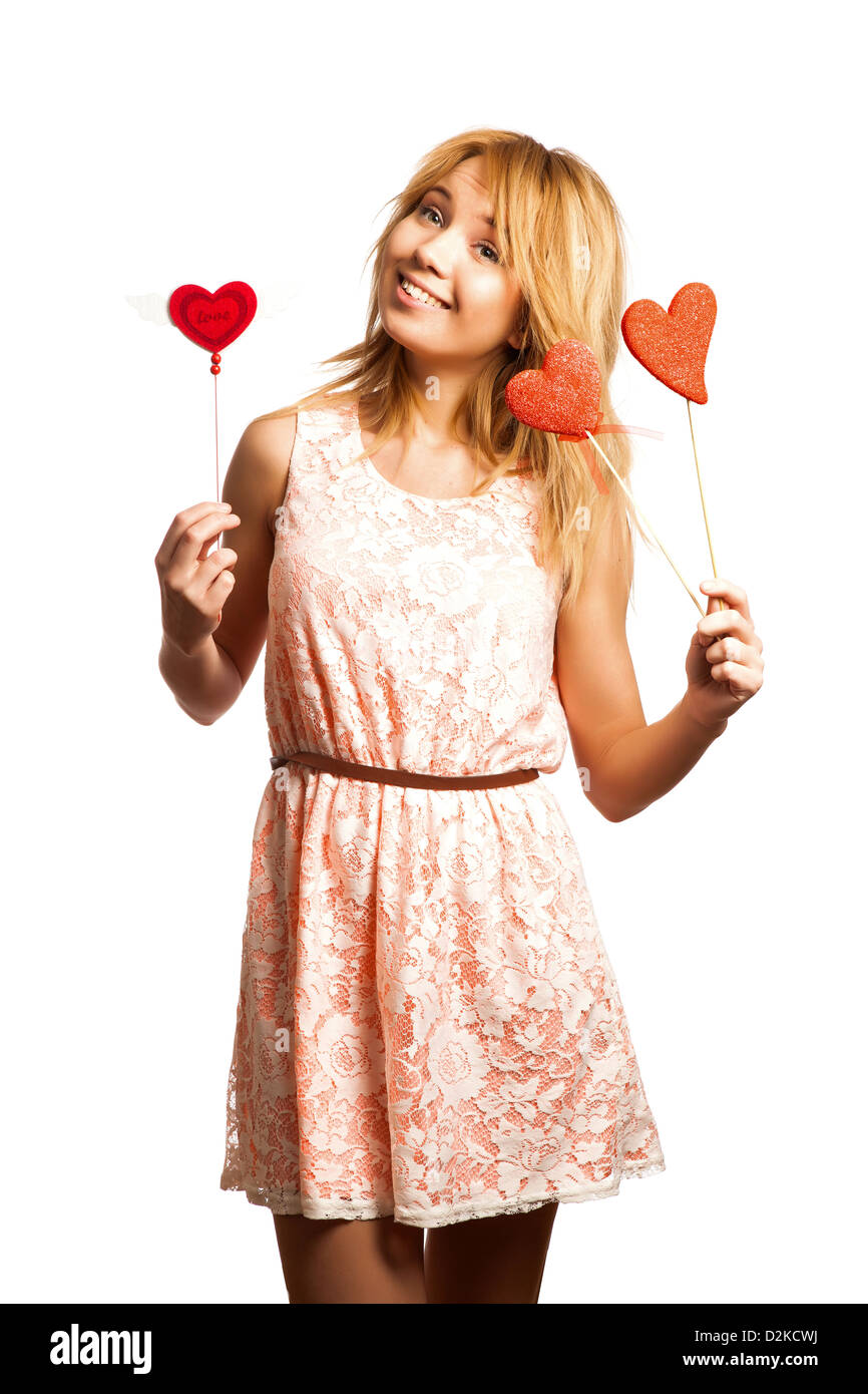 Attractive young woman holding red heart-shape and smiling Stock Photo