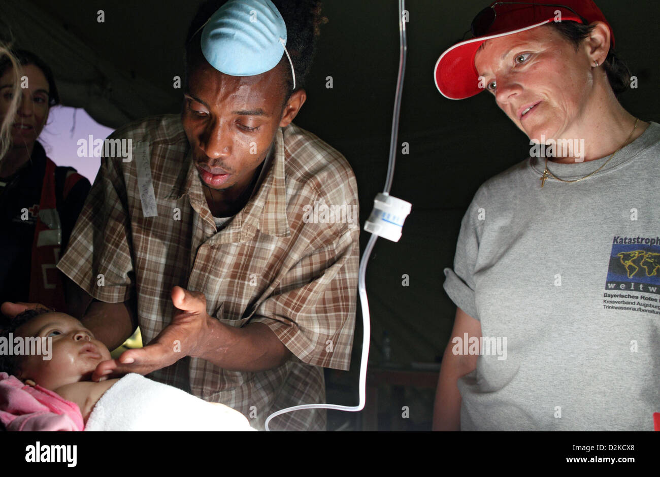 Carrefour, Haiti, concerned father with a sick boy in the ambulance tent Stock Photo